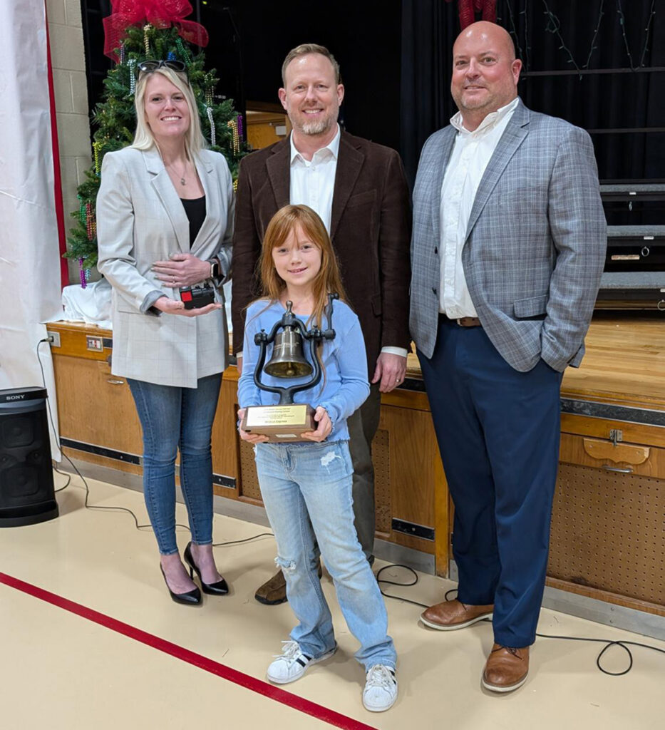 2nd grader Mya Trout from Mrs. Redman's class at Farmersville Elementary, with (l-r) Ashley Blocker, Jody Peacock and Jason May with Ports of Indiana. Mya was one of three students to submit "Wildcat Express."