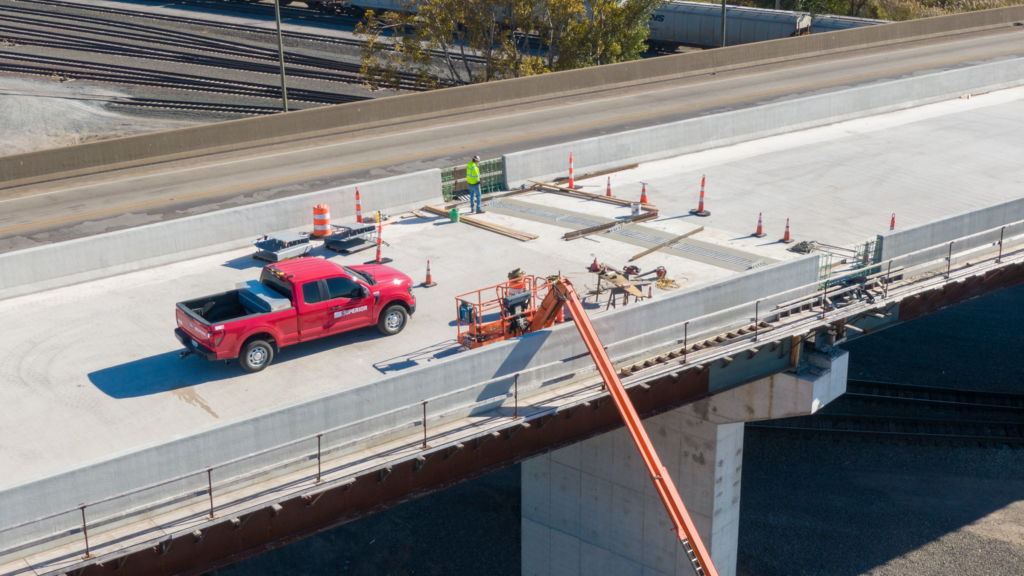 A close-up of Superior Construction employees putting finishing touches on the new State Road 249 bridge at Burns Harbor.