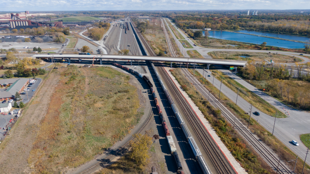 Looking east, the new State Road 249 bridge with old bridge just behind it. Below the bridges (right to left) is U.S. Hwy.12, the South Shore Line and Norfolk Southern railroad.