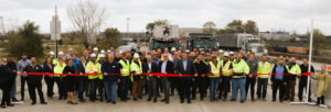 Ports of Indiana invited first responders and construction workers to join the ribbon-cutting ceremony opening the State Road 249 bridge at Burns Harbor; INDOT Commissioner Michael Smith holds the scissors