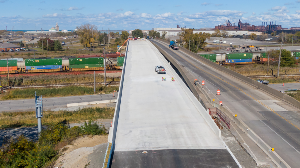 Looking north, crews put the final touches on the new State Road 249 bridge. Below, front to back, is U.S. Hwy.12, the South Shore Line, and Norfolk Southern.